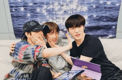 Three Young Men On Couch One Wearing Army Shirt GIF
