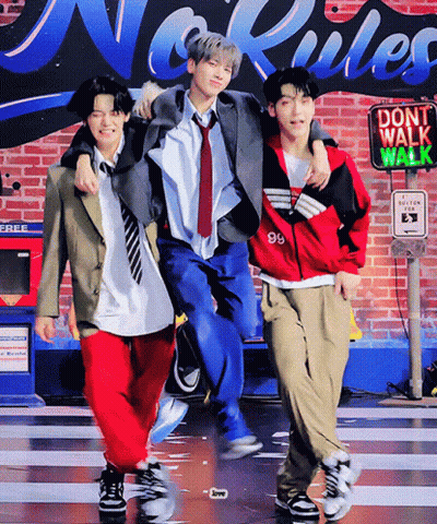 Three Young Men Posing In Front Of Do Not Walk Walk Sign GIF