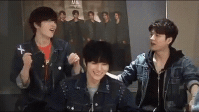 Three Young Men Sitting In Front Of Group Photo GIF
