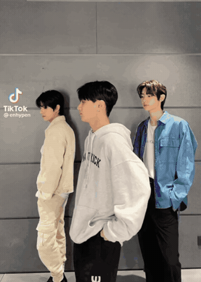 Three Young Men Standing In Front Of A Wall With Tiktok Written On The Bottom Right GIF