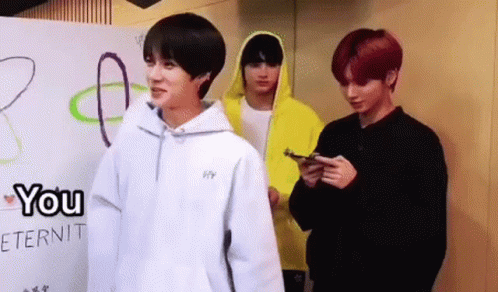 Three Young Men Standing In Front Of Wall GIF