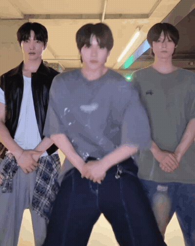 Three Young Men Standing Next To Each Other One Of Whom Is Wearing A T-Shirt That Says ' Abercrombie ' GIF