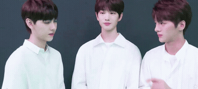 Three Young Men Wearing White Shirts Are Standing Next To Each Other GIF