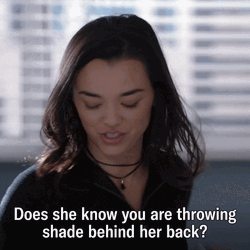 Throwing Shady Behind Her Back GIF