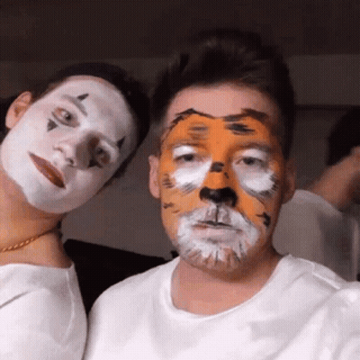 Tiger Face Man Next To Clown Face Man GIF