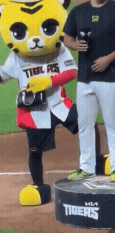 Tiger Mascot On Podium With Man Behind GIF