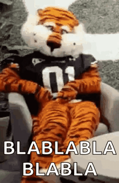 Tiger Mascot Sitting In Chair Saying Blablabla Blabla GIF