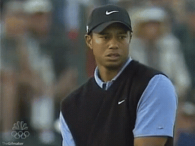 Tiger Woods Is Wearing A Nike Hat And A Blue Shirt . GIF