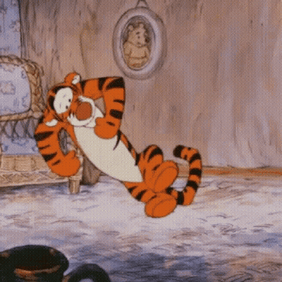Tigger From Winnie The Pooh Is Laying Down In A Living Room GIF