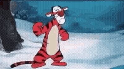 Tigger From Winnie The Pooh Is Standing In The Snow And Looking At The Camera . GIF