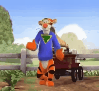 Tigger From Winnie The Pooh Is Standing Next To A Red Wagon And Wearing A Blue Shirt . GIF
