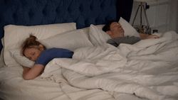 Tired Couple In Bed Sleeping In Distance GIF