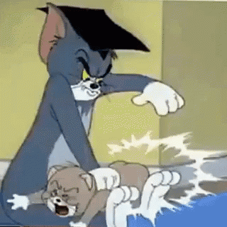 Tom And Jerry Are Playing With Each Other In A Room . Tom Is Wearing A Graduation Cap . GIF