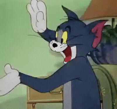 Tom From The Cartoon Tom And Jerry Is Waving His Hand In A Room . GIF