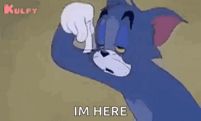 Tom From Tom And Jerry Is Standing In Front Of A Wall . GIF