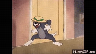 Tom From Tom And Jerry Is Wearing A Hat And Dancing In A Doorway . GIF