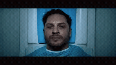 Tom Hardy Is Laying In A Hospital Bed With His Eyes Closed And A Beard . GIF