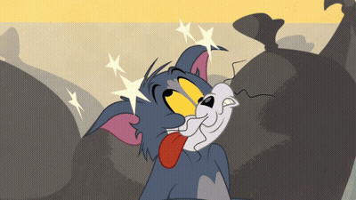 Tom Sticking Tongue Out By Trash Bags GIF