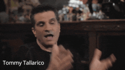 Tommy Tallarico In Black Hat With Crossbones Logo GIF