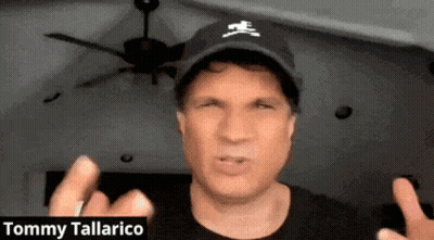 Tommy Tallarico In Black Hat With Crossbones Logo GIF