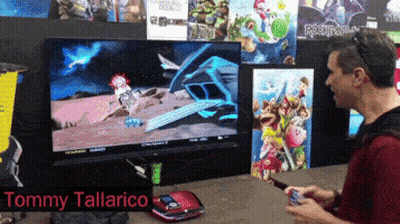 Tommy Tallarico Playing Video Game On Large Screen GIF