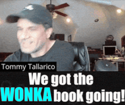 Tommy Tallarico Sitting In Front Of We Got The Wonka Book Going Sign GIF
