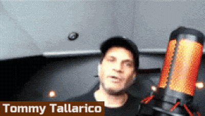 Tommy Tallarico Standing In Front Of Microphone In Dark Room GIF