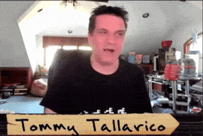 Tommy Tallarico Standing In Front Of Sign GIF