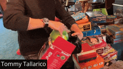 Tommy Tallarico Standing In Front Of Toys GIF