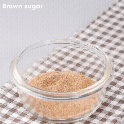 Tongs Stirring Brown Sugar In Glass Bowl GIF