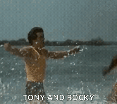Tony And Rocky Men Arms Outstretched In Water GIF