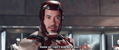 Tony Stark Is Wearing A Helmet And Saying Come On I Ain 'T Scared Of You . GIF