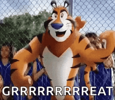 Tony The Tiger Is Standing In Front Of A Chain Link Fence With A Bunch Of People Behind Him . GIF
