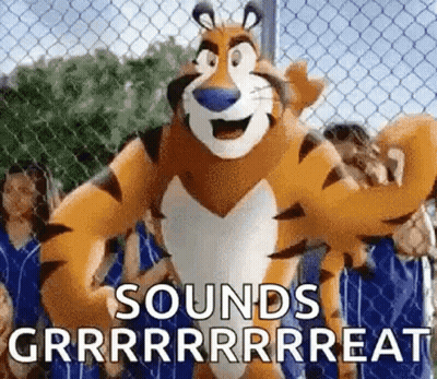 Tony The Tiger Standing In Front Of Chain Link Fence With People Behind GIF