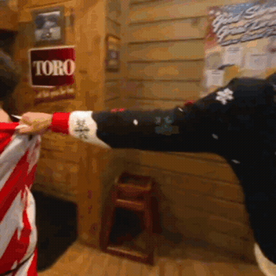 Toro Sign Hangs Behind Person GIF