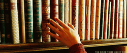 Touching Books At The Library GIF