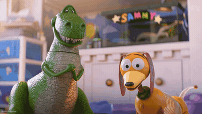 Toy Dinosaur And Toy Dog Standing By Sammy Sign GIF