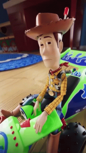 Toy Story Character Sitting In Green Vehicle GIF