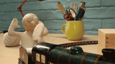 Toy Train Next To Cup Of Pencils GIF