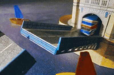 Toy Truck Driving Through Tunnel Under Tower GIF