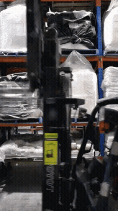 Toyota Forklift In Warehouse With Bags On Shelves GIF
