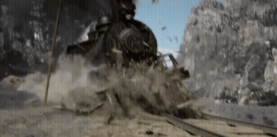 Train Going Down Tracks In Mountain Range GIF