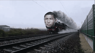 Train With Man Face Going Down Tracks GIF