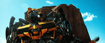 Transformer Robot Standing In Front Of Desert Rock GIF