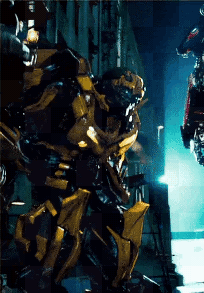 Transformer Standing In Front Of Building At Night GIF