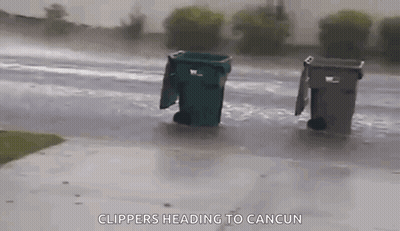 Trash Cans Sitting In Rain On Side Of Road GIF