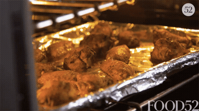 Tray Of Food In Oven With Number 52 GIF