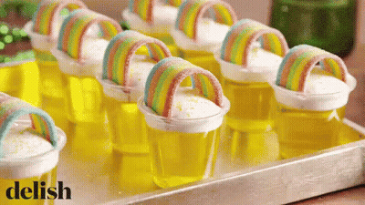 Tray Of Jelly Cups With Rainbows Saying Delish GIF