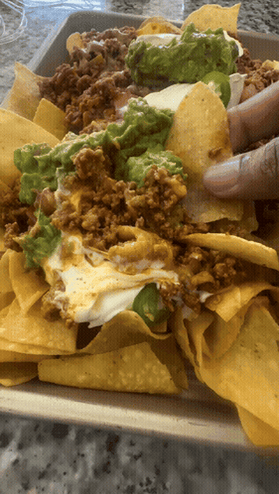 Tray Of Nachos With Guacamole And Cheese GIF