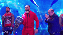 Tribal Chief Wearing Red Suit Raising Belt GIF